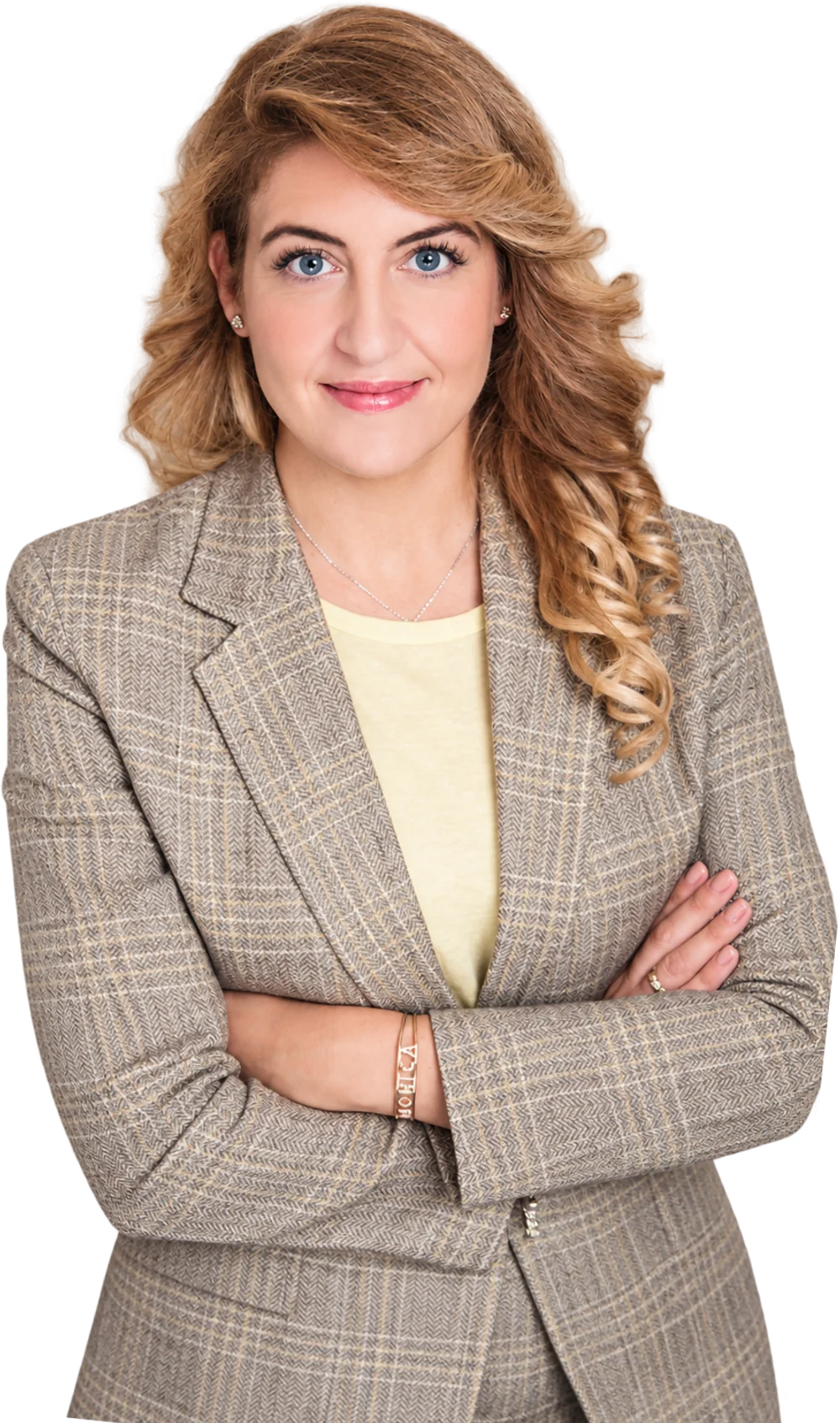 Dr. Monica Perna in a tailored blazer, arms crossed, smiling
